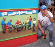 A Guatapé local poses by a pub-front “socket” for which he served as a model.