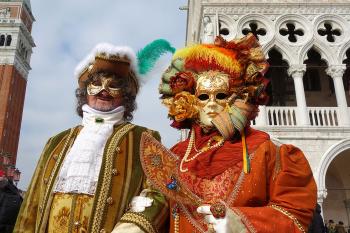 Revelers in ornate, outrageous costumes and colorful masks descend upon Venice during Carnival. Photo by Simon Griffith