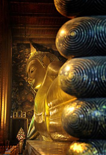 Toes of the 46-meter-long reclining Buddha at Wat Pho temple in Bangkok, Thailand. The figure was built with bricks, shaped with plaster, then gilded.