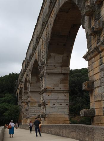 The Pont du Gard crosses the river Gardon in southern France. Note the blocks sticking out used to hold scaffolding during construction and repairs.
