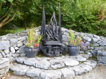 Wood-crafted throne in the Beltaine garden — Brigit’s Garden.