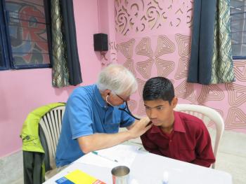 Dr. Rob Griffith examining a student at the school.