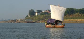 A canopied, square-sailed boat heading up the Ganges River in India. Photo by Marilyn Jestes