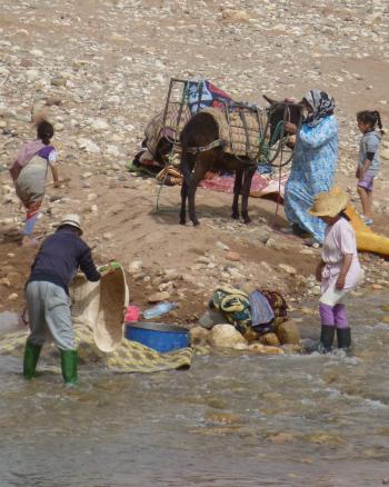 Locals washing clothes in a river near Ouarzazate, Morocco. Photo by Randy Keck
