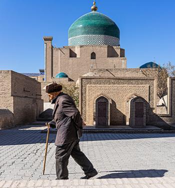 Man walking past Juma Mosque in Khiva, Uzbekistan. Photo by Jered Gorman for MIR Corporation
