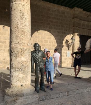 Deanna Palić, arm in arm with a bronze statue of Antonio Gades, the  Spanish flamenco dancer and choreographer, in Old Havana's Cathedral Square.