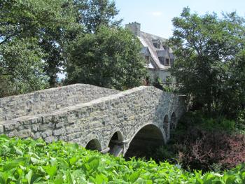 A stone bridge and house at La Seigneurie Gardens. 