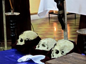 Three skulls, one of which will be chosen to be part of a Day of the Dead procession, at the church in San José, Petén, Guatemala.