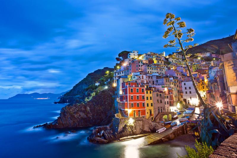 The picture-perfect setting of the Cinque Terre villages (in this case, Riomaggiore) draws millions of tourists annually. Photo by Dominic Arizona Bonuccelli