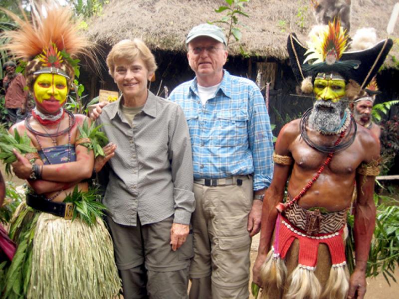 Jean and Fred DeVinney flanked by tribal members at the Tumbuna Sing-Sing in Papua New Guinea. 