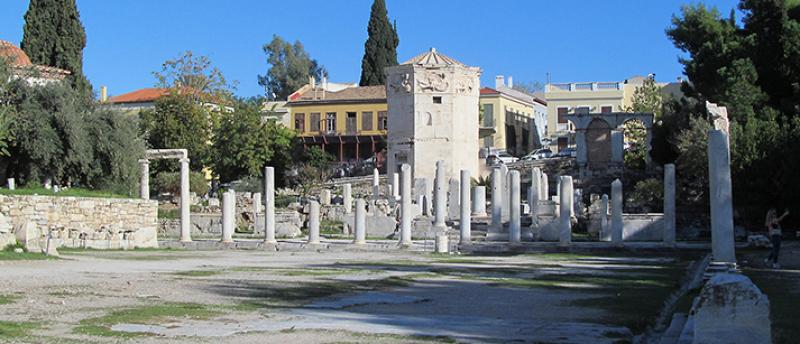 Open courtyard of the Roman Agora in Athens, with the Tower of the Winds in the background.